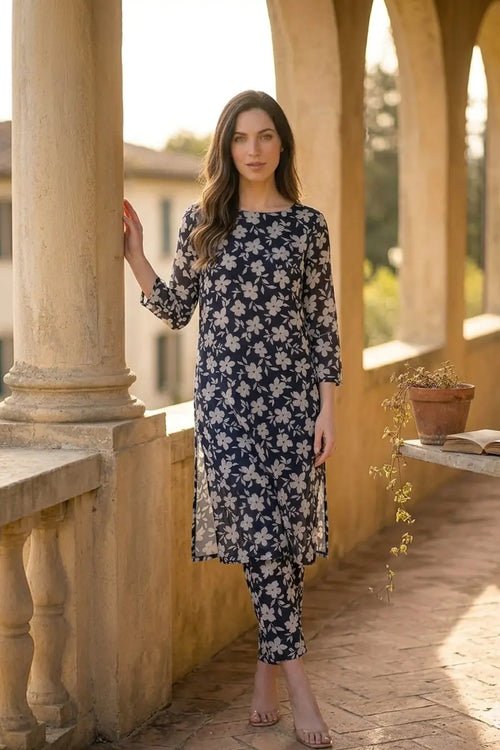 Woman modeling the Dorikhas Midnight Blossom 2 piece printed lawn unstitched suit featuring a navy blue and white floral pattern.