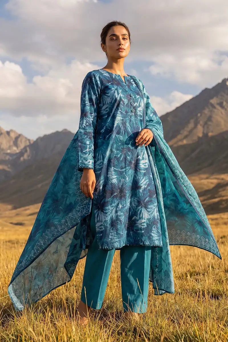 Low-angle view highlighting Oceanic Mirage 3 piece blue printed lawn suit and dupatta by Dorikhas Pakistan.