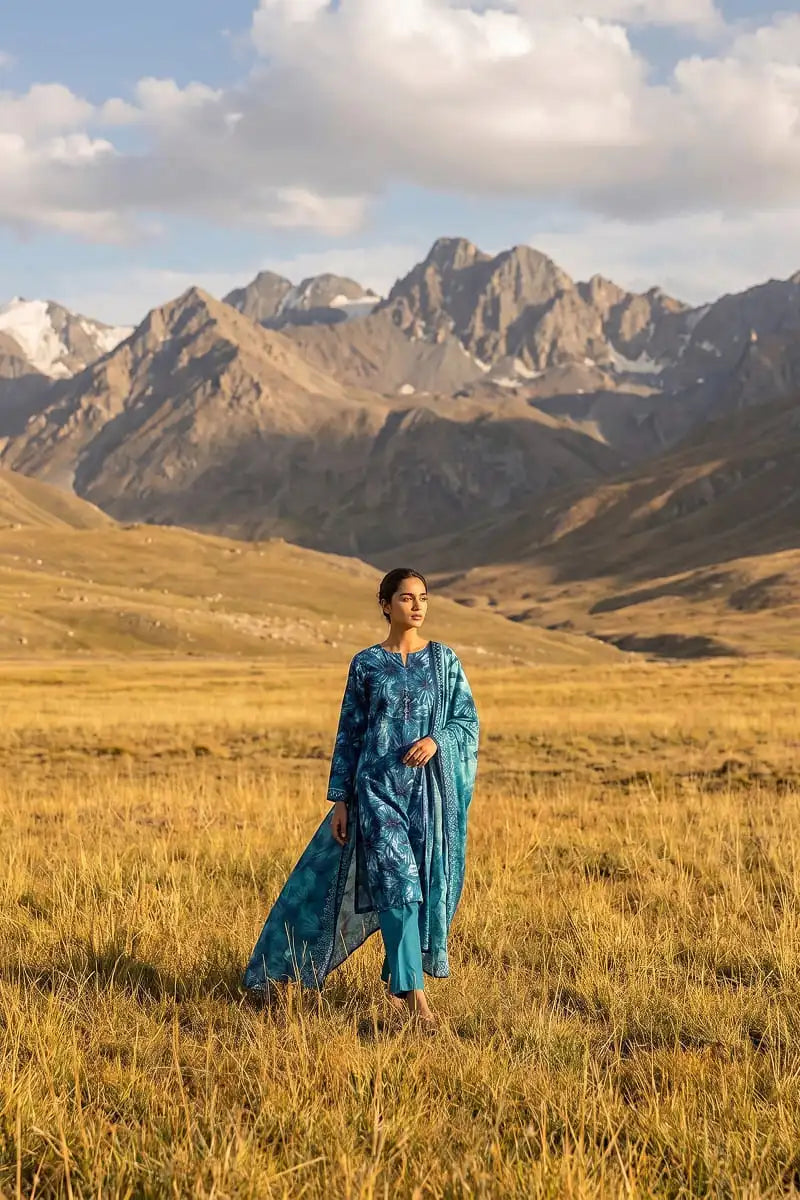 Wide shot of model walking in Oceanic Mirage 3 piece printed lawn suit by Dorikhas Pakistan.
