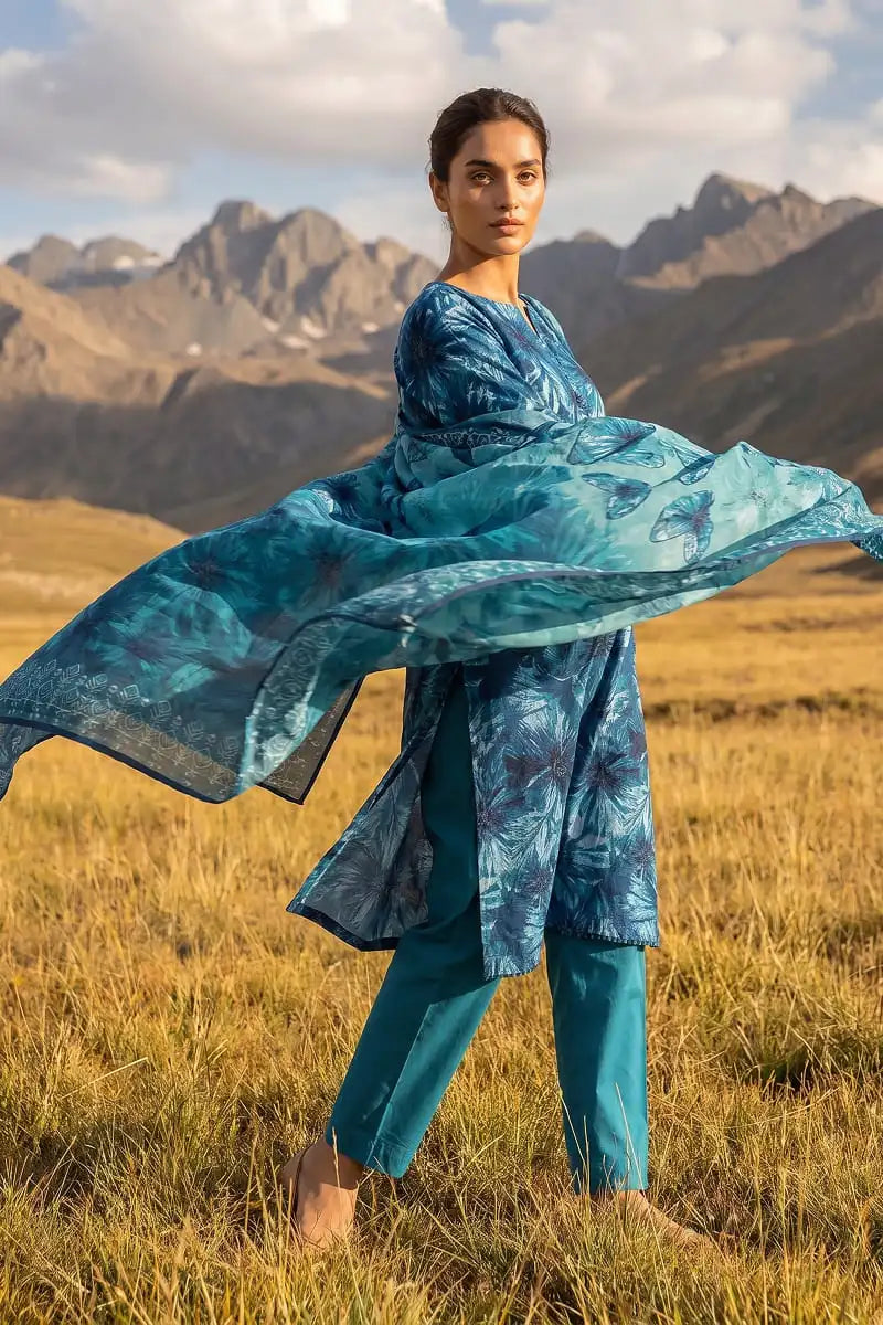 Action shot of Oceanic Mirage 3 piece blue printed lawn suit showing flowing dupatta by Dorikhas Pakistan.