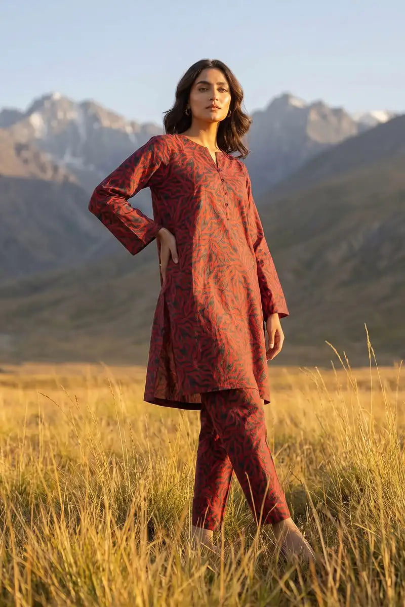 Three-quarter pose of model wearing Coral Maze 2 piece allover printed lawn suit by Dorikhas Pakistan.