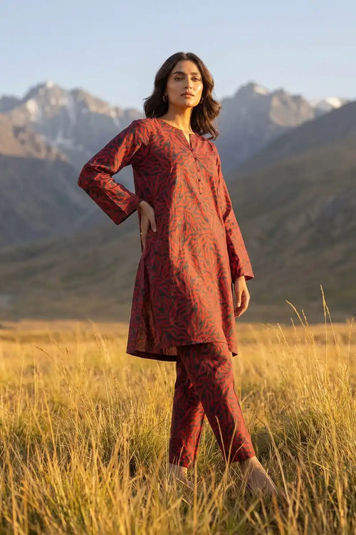 Three-quarter pose of model wearing Coral Maze 2 piece allover printed lawn suit by Dorikhas Pakistan.