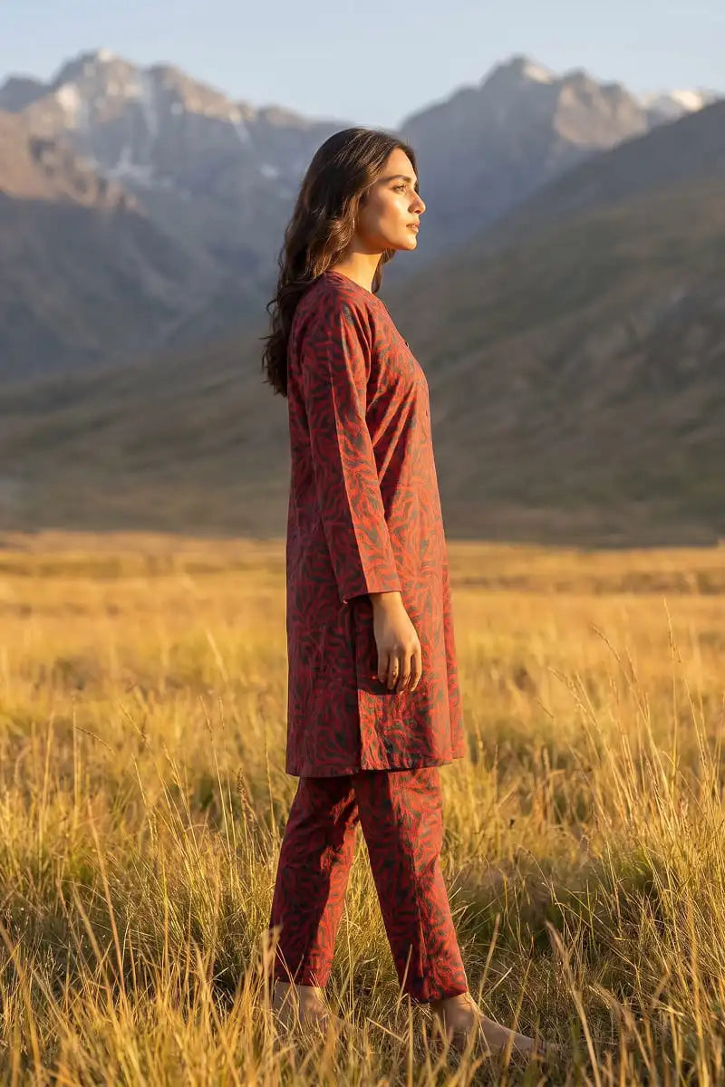 Side profile view of model wearing Coral Maze 2 piece allover printed lawn collection by Dorikhas Pakistan.