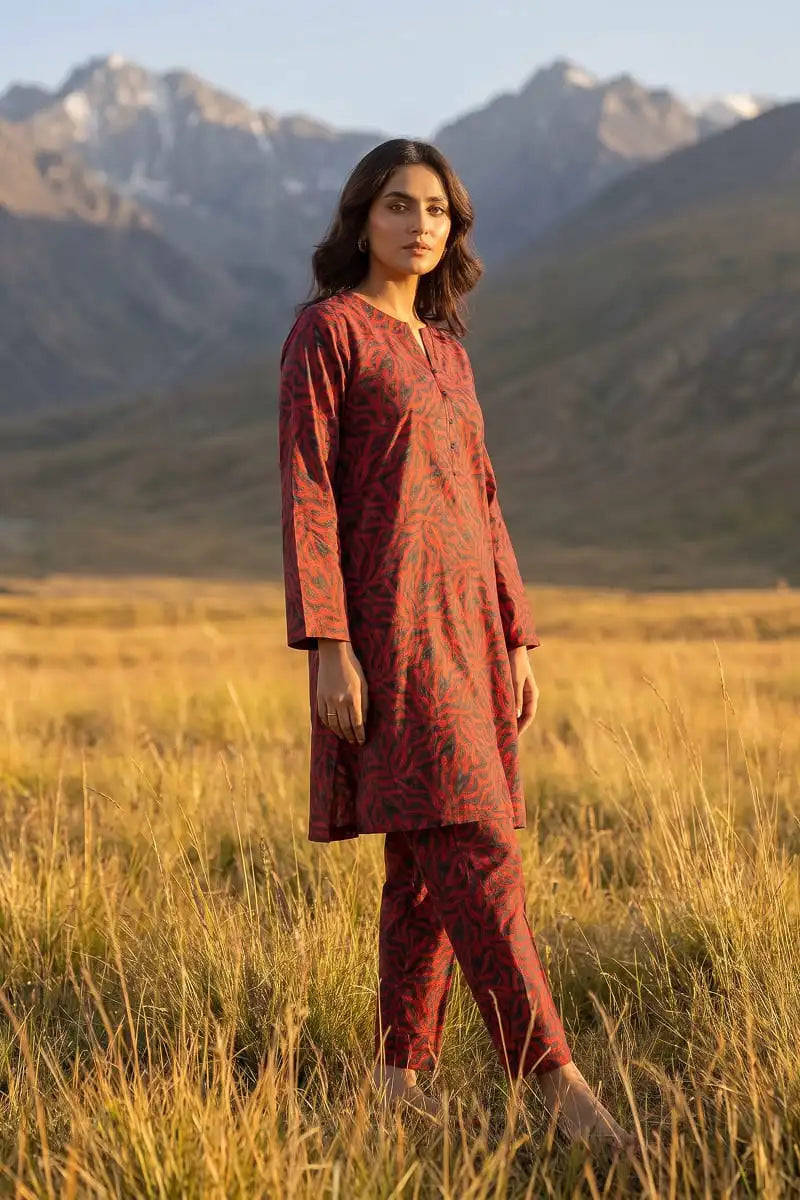 Front angle shot of model posing in Coral Maze 2 piece coral red printed lawn set by Dorikhas Pakistan.