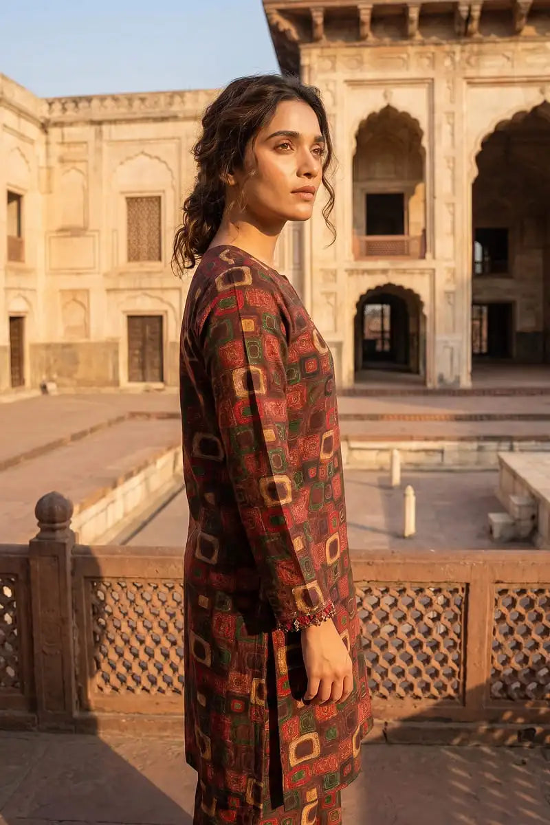 Side profile close-up of a model wearing the Dorikhas Pakistan Retro Grid allover printed lawn tunic, highlighting the sleeve details and fabric drape.